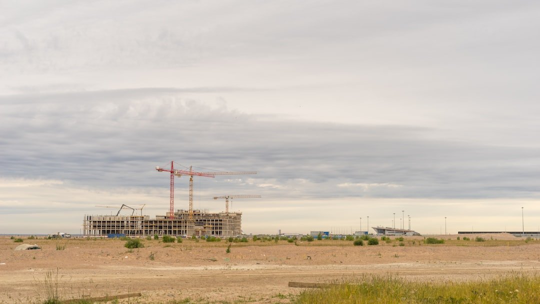 Construction project delivery with cranes illustrating AMAALA Triple Bay project controls and phased handover