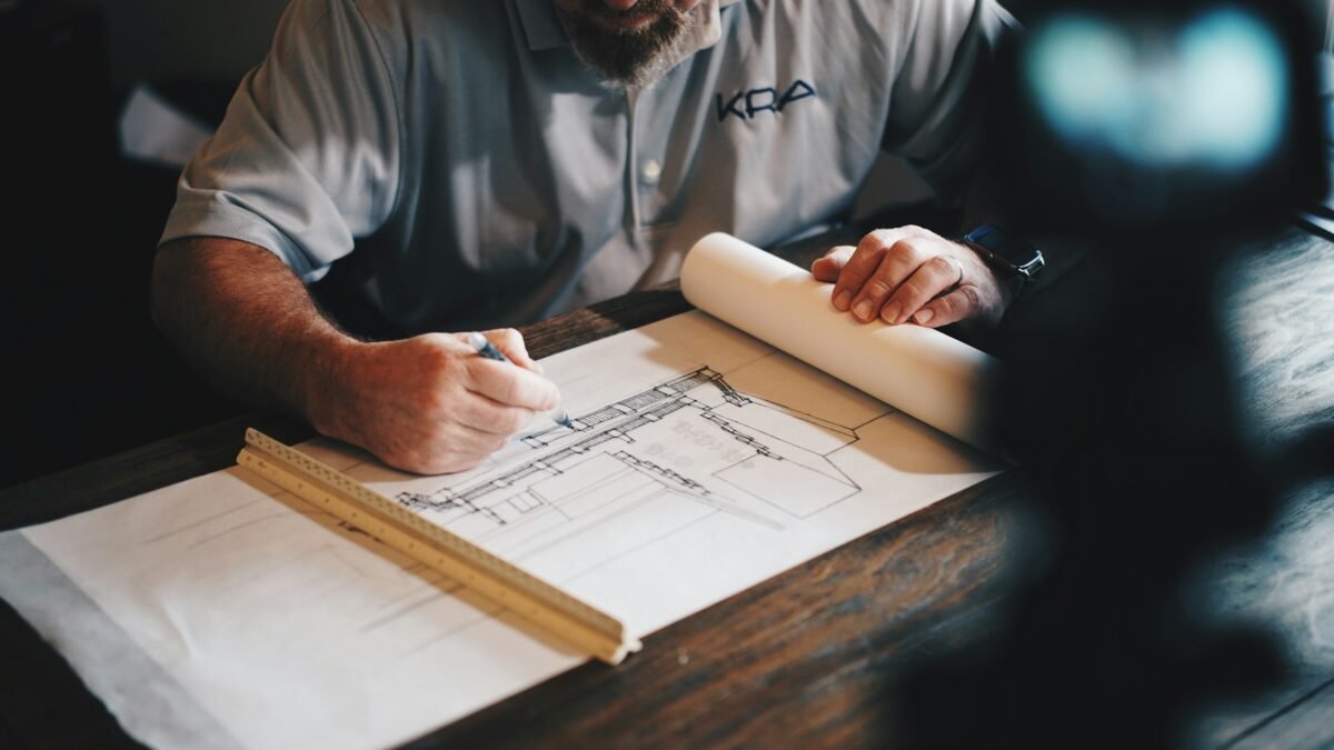 Planner reviewing drawings while diagnosing a Primavera P6 schedule finish-date problem